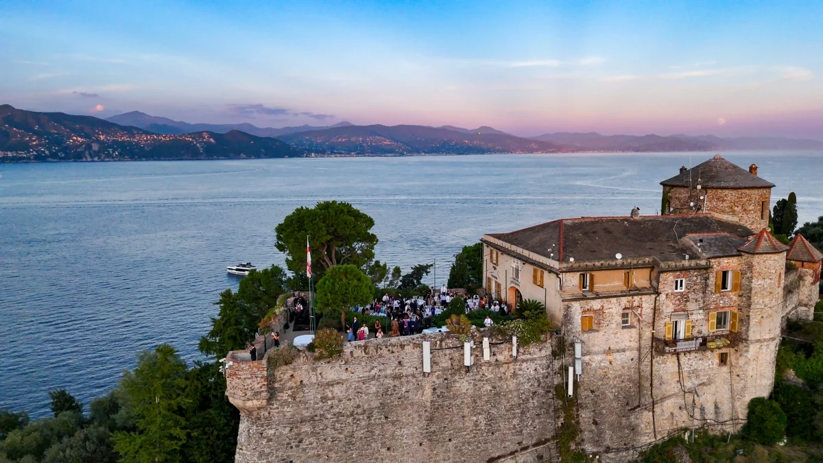 Il Castello Brown sopra Portofino al tramonto, con la festa sulla terrazza